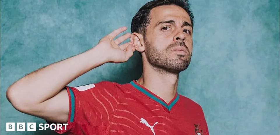 Player in red national team jersey posing for photo