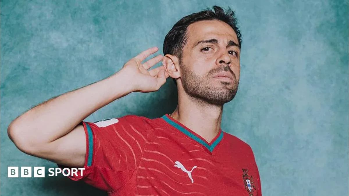 Player in red national team jersey posing for photo