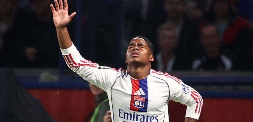Player with arms raised during match celebration