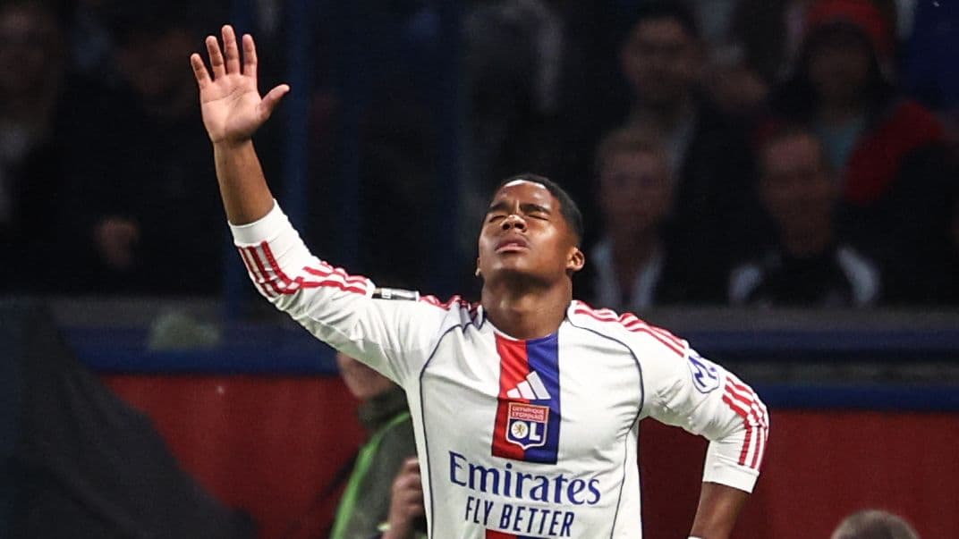 Player with arms raised during match celebration