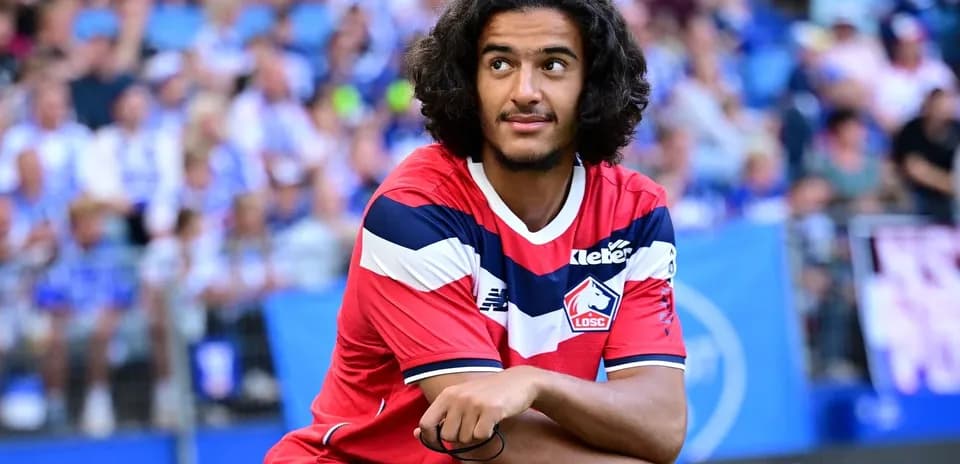 Player sitting on the pitch during match warm-up