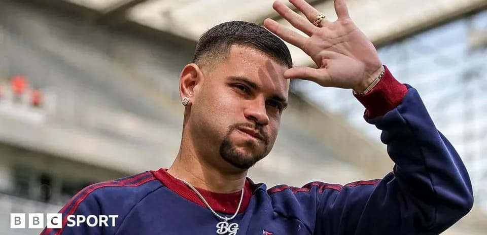 Player waving during pre-match warm-up at stadium