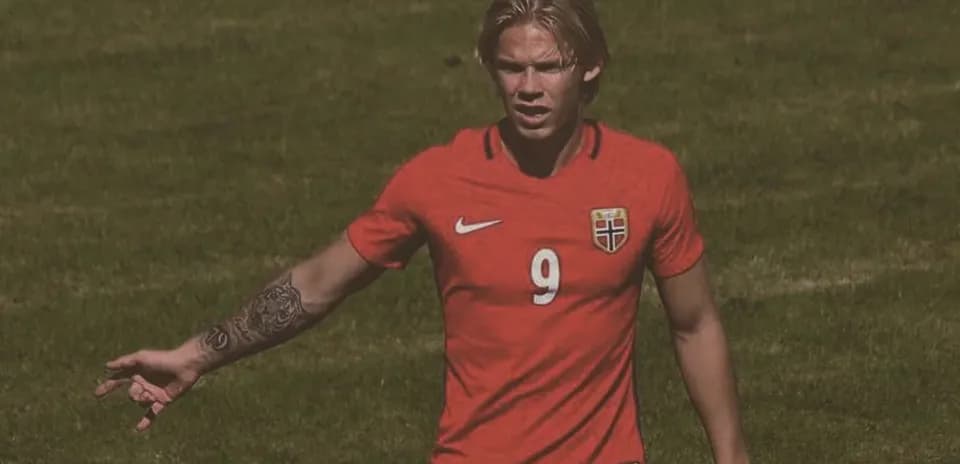 Player in red jersey gesturing on the field