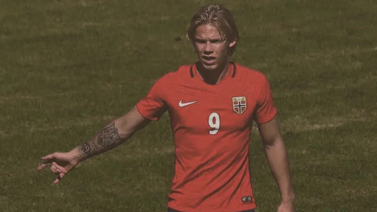 Player in red jersey gesturing on the field