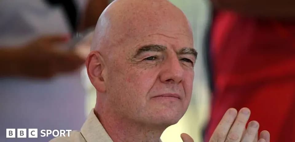 Man with bald head and clasped hands in audience