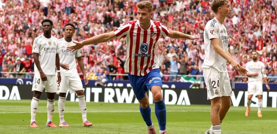 Atletico player celebrating a goal against Real Madrid