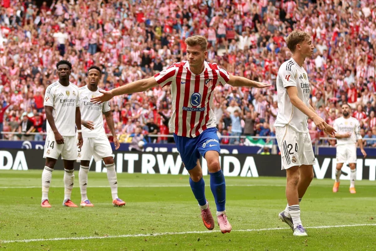 Atletico player celebrating a goal against Real Madrid