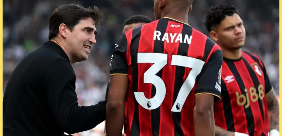 Coach discussing strategy with Bournemouth players during match