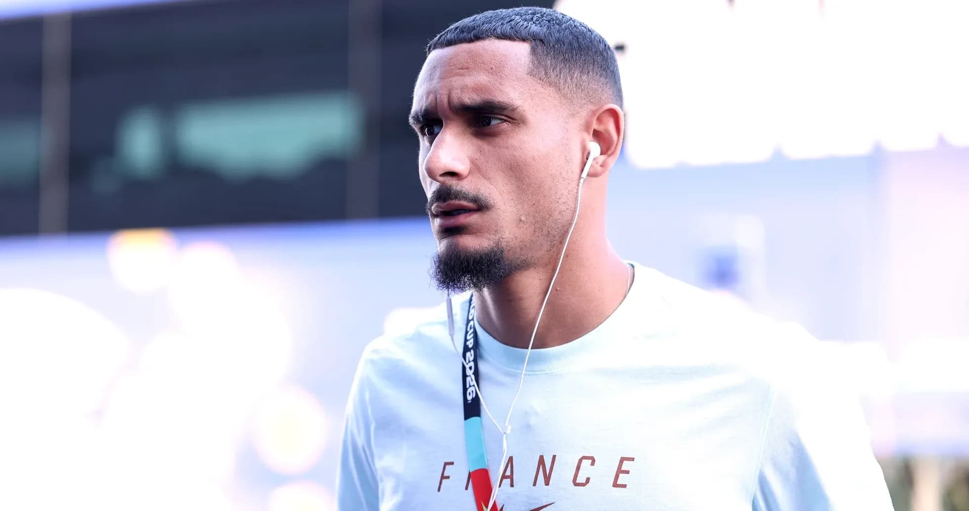 Player wearing headphones, walking in team gear