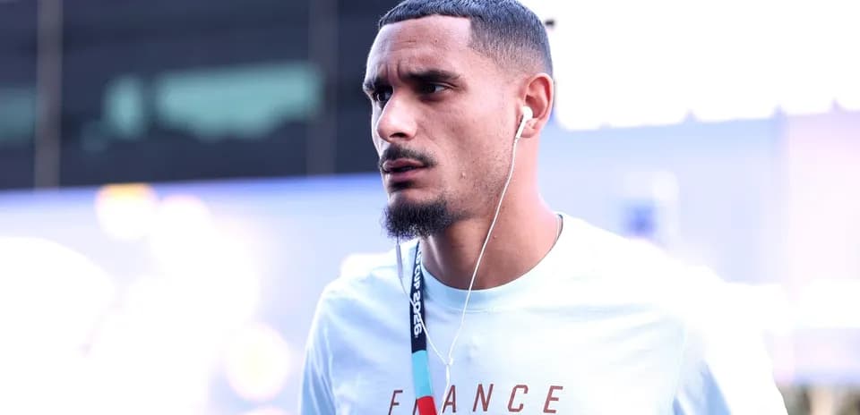 Player wearing headphones, walking in team gear