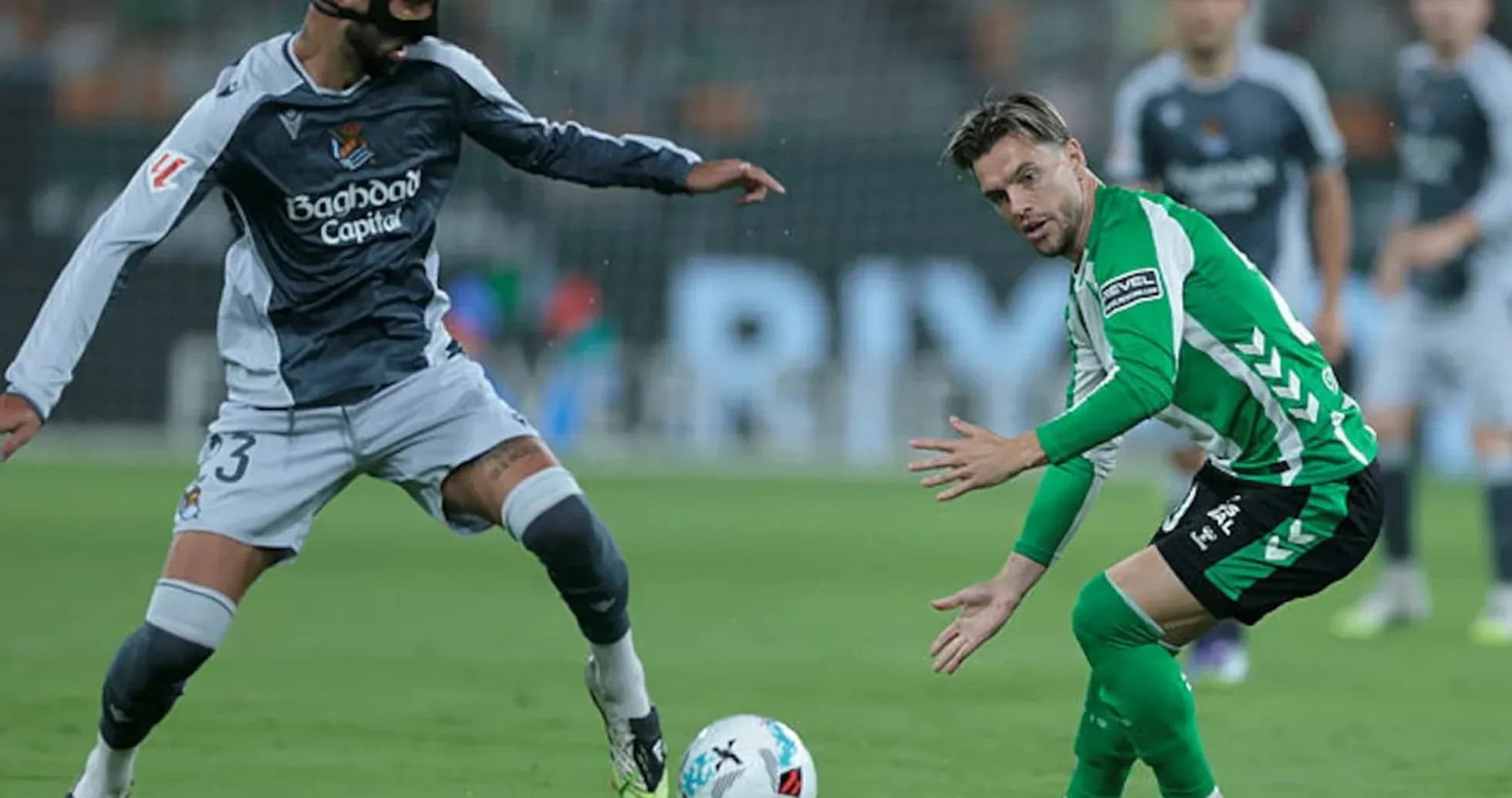 Real Sociedad player challenging Real Betis player