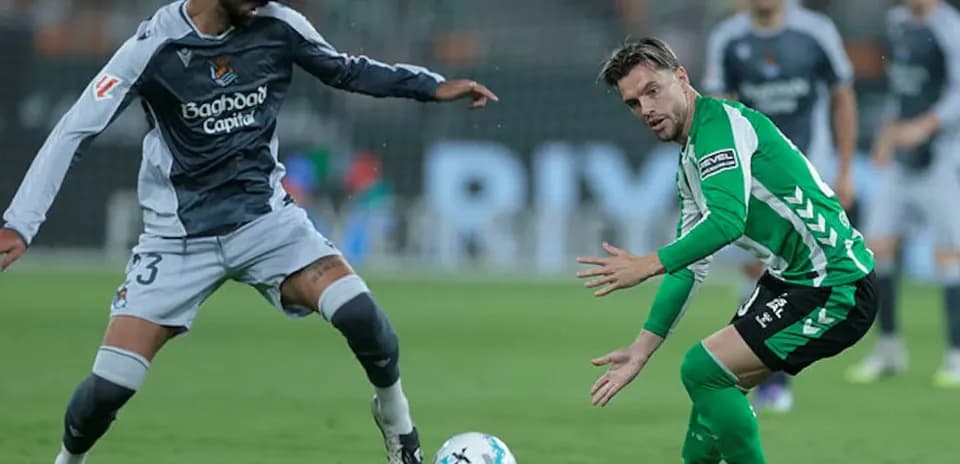 Real Sociedad player challenging Real Betis player