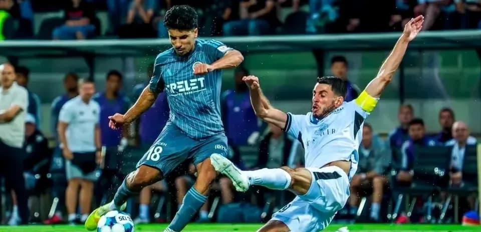 Player tackling opponent during UEFA Champions League match