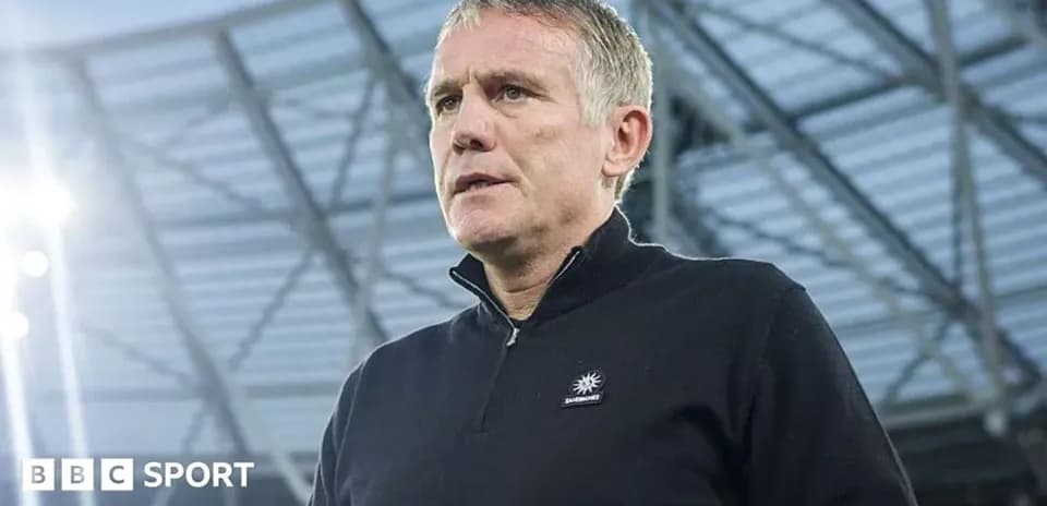 Coach standing in stadium before the match