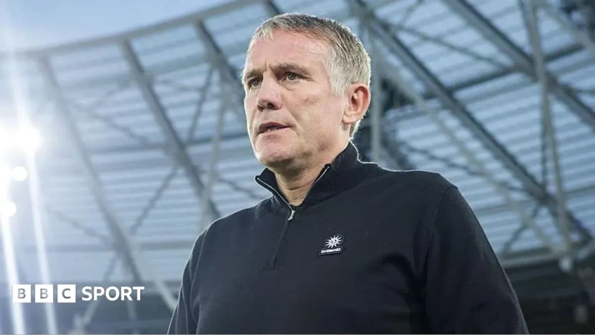 Coach standing in stadium before the match