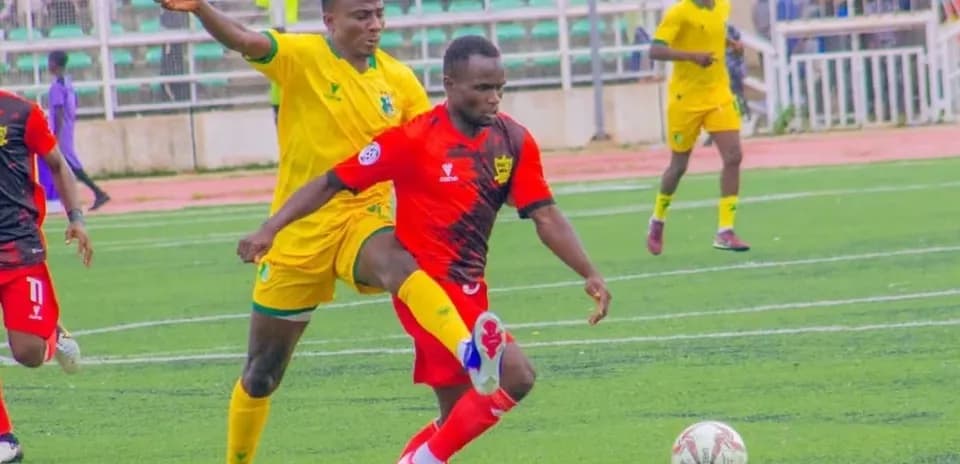 Kano Pillars player dribbling against Doma United