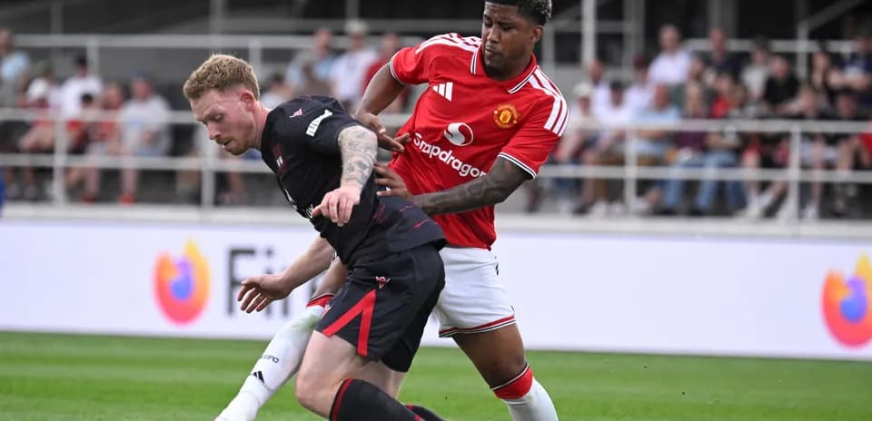 Player from Manchester United challenging opposing player