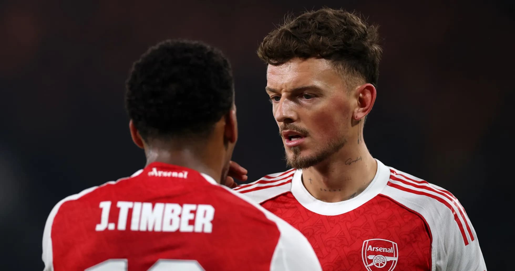 Two Arsenal players discussing on the field