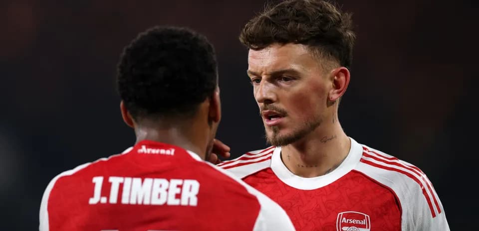 Two Arsenal players discussing on the field