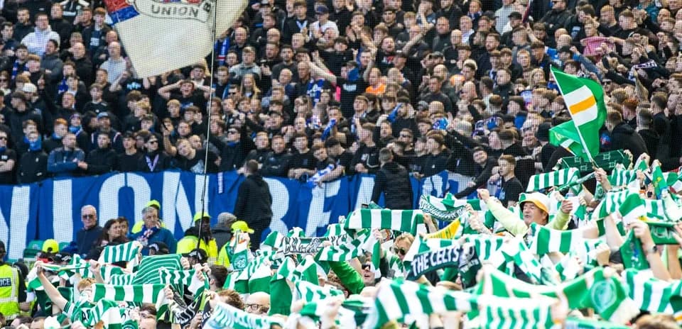 Fans waving scarves during a football match