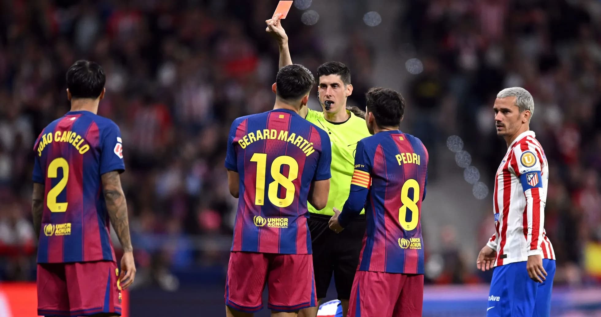 Referee showing red card to Barcelona player