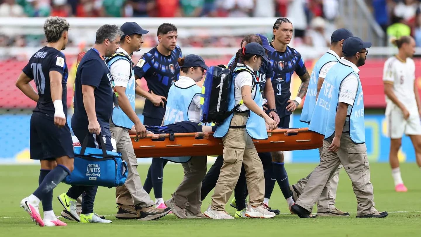 Medical team carrying player on stretcher during match