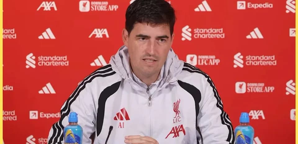 Manager speaking at press conference with sponsors backdrop