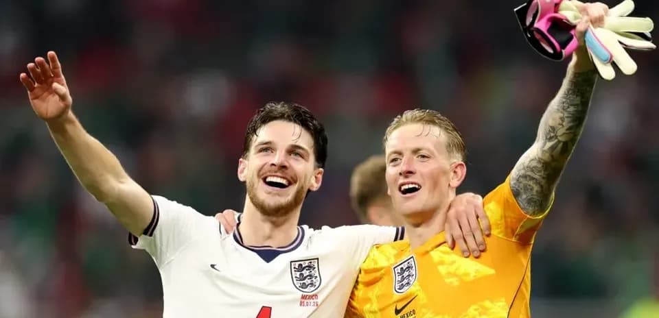 Two England players celebrating a victory together