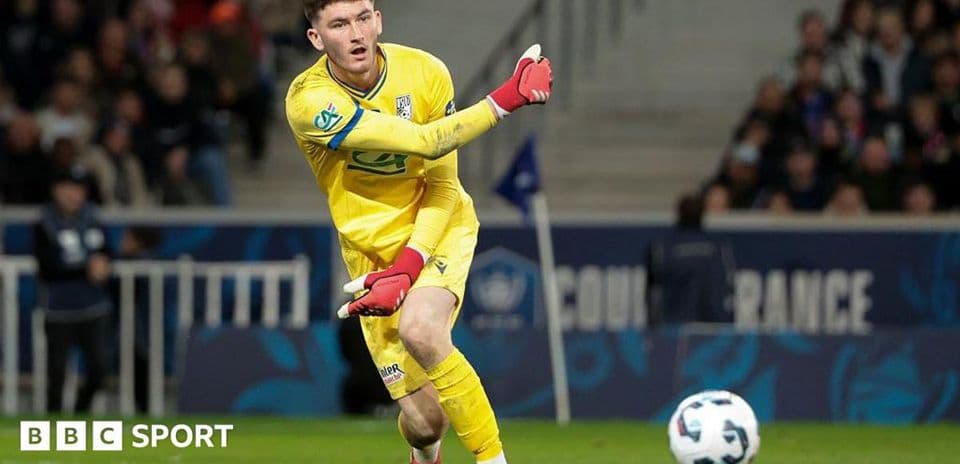 Goalkeeper in yellow kit making a throw