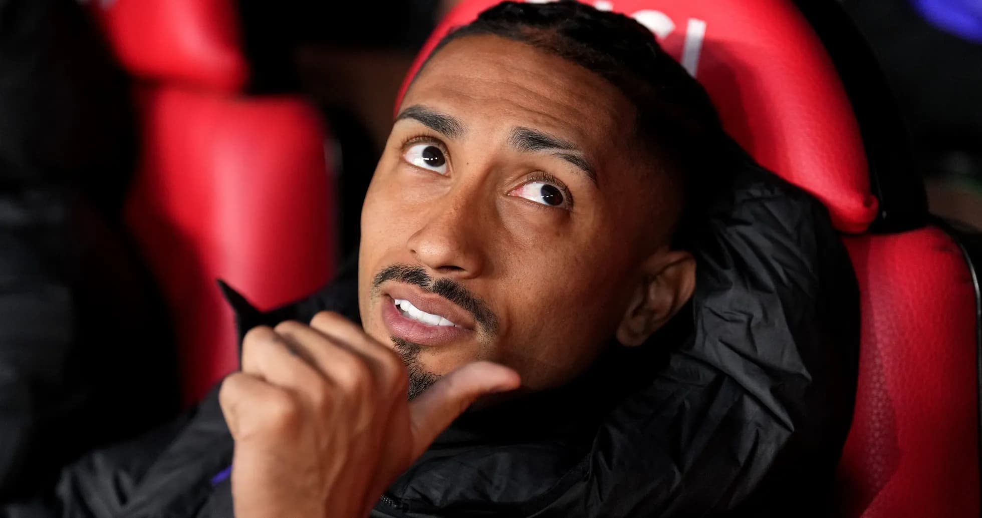 Player sitting on bench looking upwards