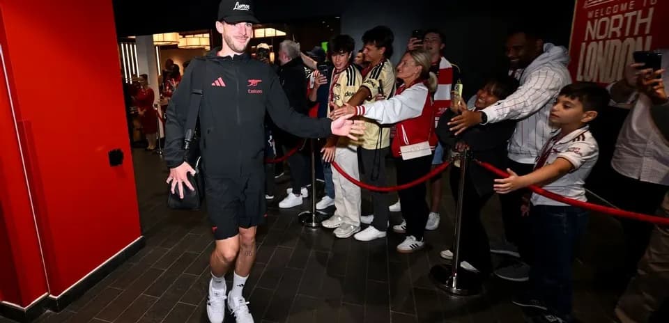 Player greeting fans outside the stadium entrance
