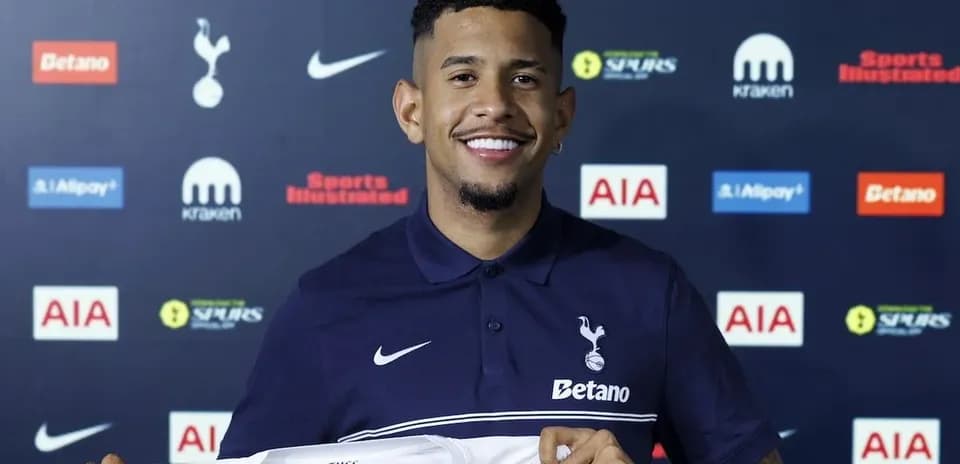 Player holding Tottenham Hotspur jersey during signing event
