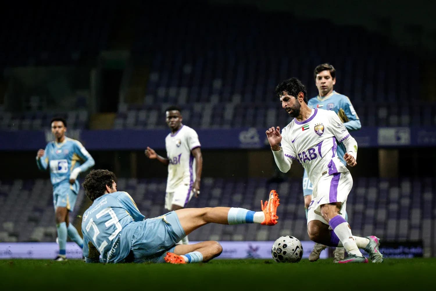 Player dribbling past goalkeeper during U23 match