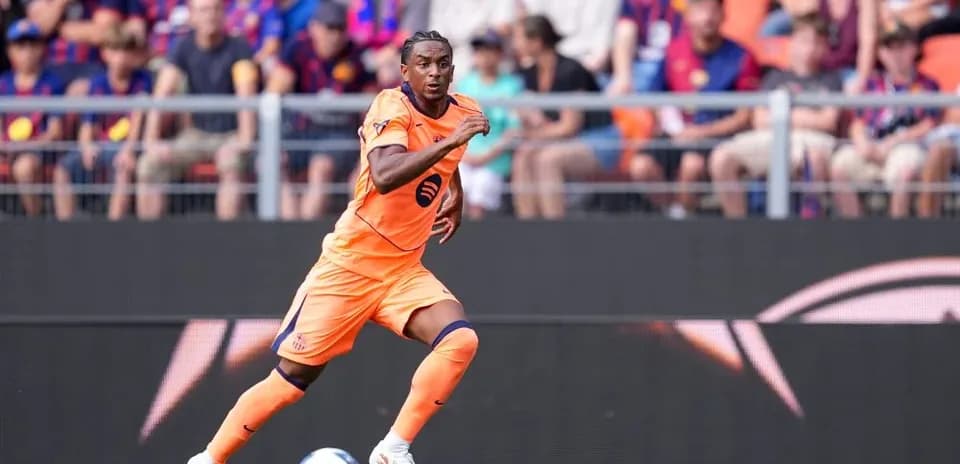 Player in orange kit running on the pitch