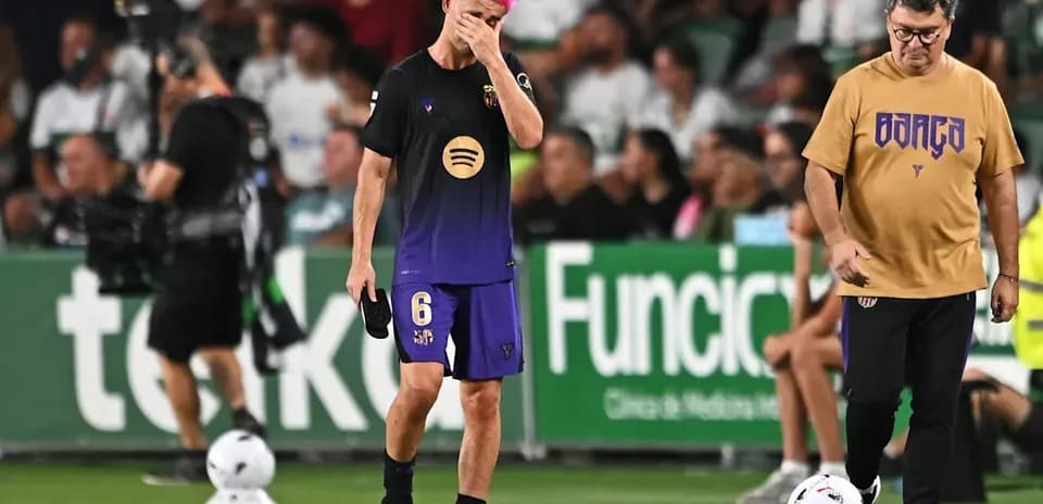 Player with pink hair walking off field during match