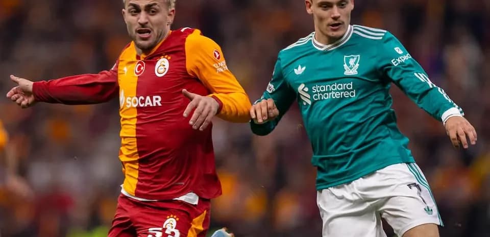 Galatasaray player and Liverpool player competing for ball