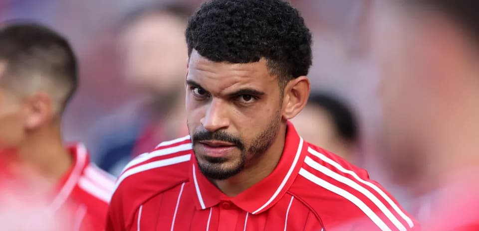 Player in red jersey preparing for the match
