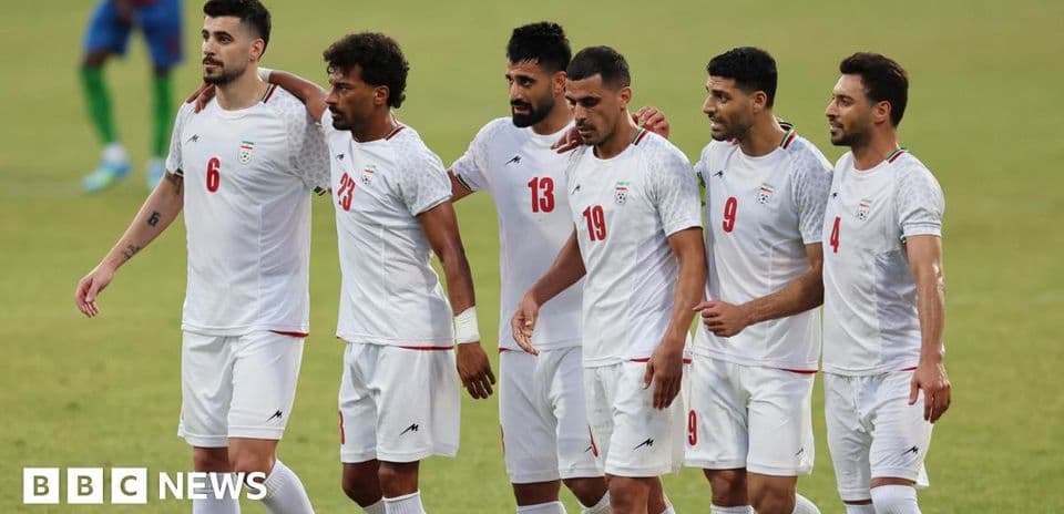 Iranian football players celebrating together on the field