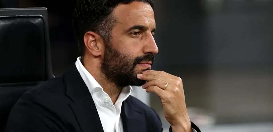 Man in a suit seated, deep in thought