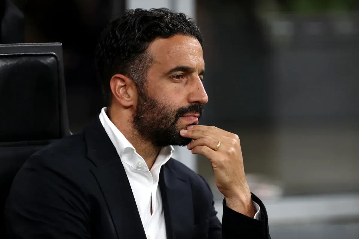Man in a suit seated, deep in thought