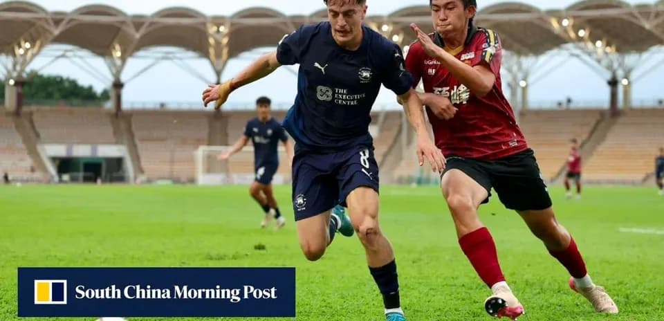 Player in blue shirt evading opponent in red shirt