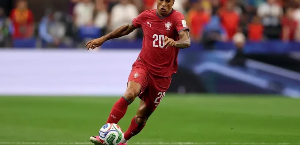 Player in red jersey dribbling ball on field