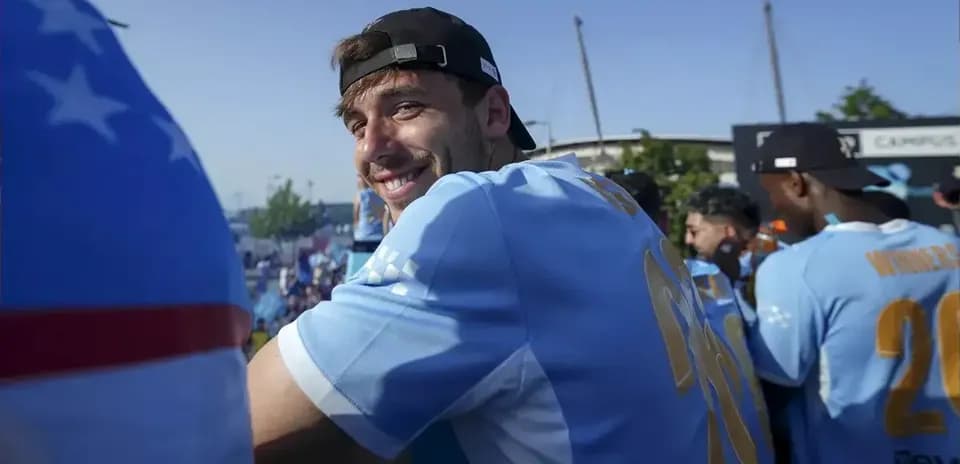 Player smiling while celebrating with teammates