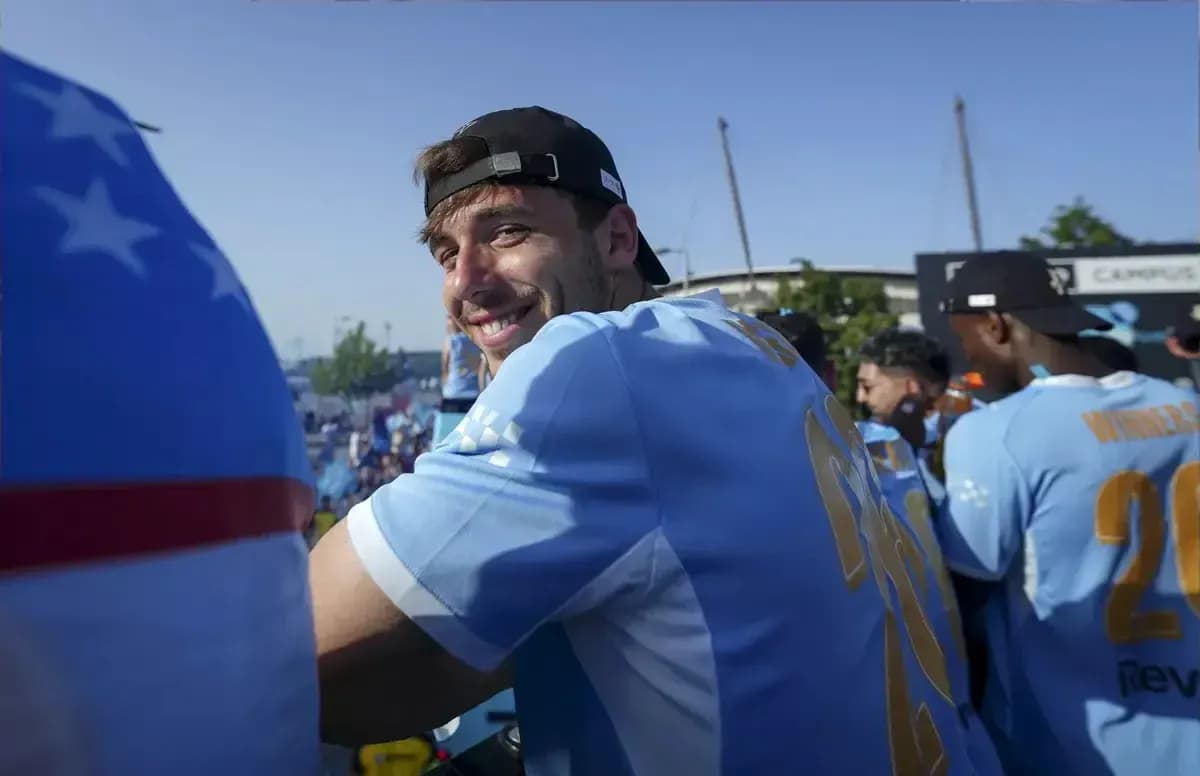 Player smiling while celebrating with teammates