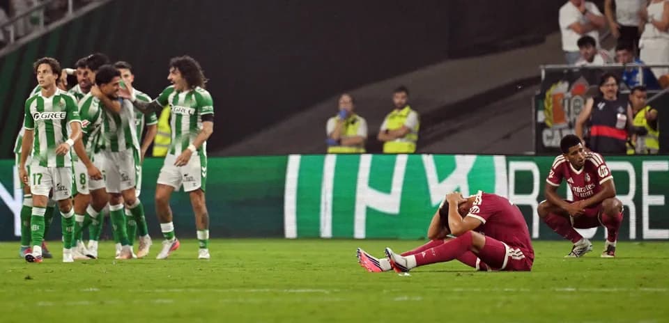 Players reacting after a match, one sitting dejected