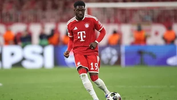 Player in Bayern Munich kit dribbling ball on pitch