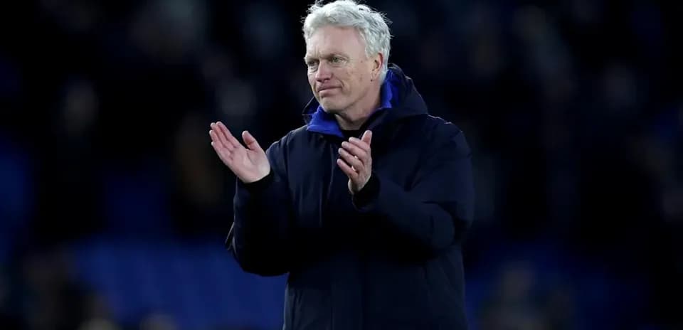 Manager clapping to fans after the match