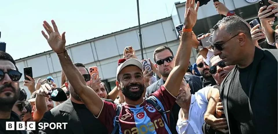 Player waving to fans during arrival at stadium