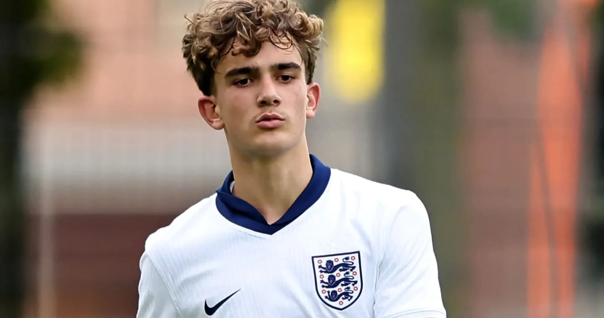 Young player in England football kit on pitch
