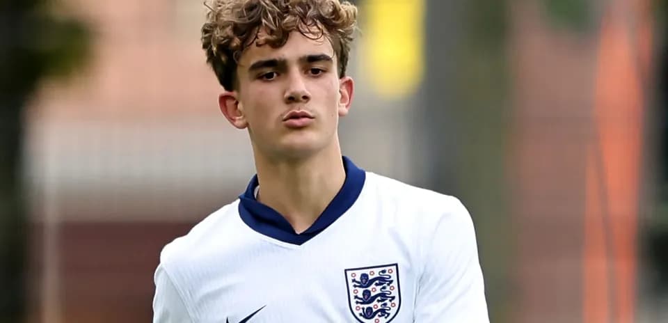 Young player in England football kit on pitch
